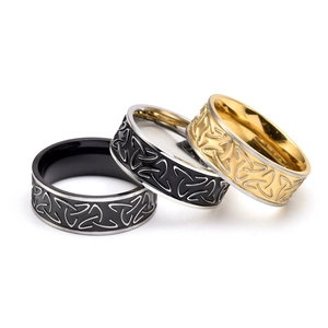 Three men's stainless steel rings featuring etched Celtic knots in black, gold, and silver