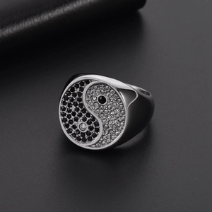 Detailed view of polished Tai Chi Yin Yang ring with black and white zircon stones