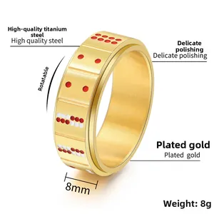 Detail view of 8mm rotating gold titanium steel ring with red and white domino dots