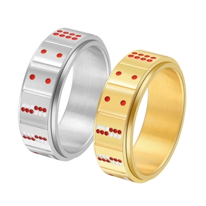 Detailed view of silver and gold spinner rings with poker-inspired red and white dots