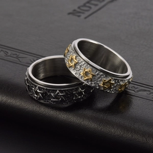 Detail of vintage rotating star rings with hammered texture and rustic rock finish