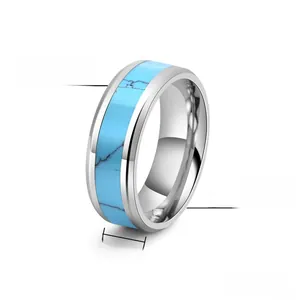 Macro detail of 8mm tungsten steel ring with polished edges and turquoise stone inlay