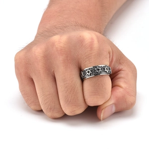 Detail of vintage rotating titanium ring featuring engraved hexagram star patterns