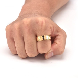 Detail of a rotating gold spinner ring for men with red and white gambling motif