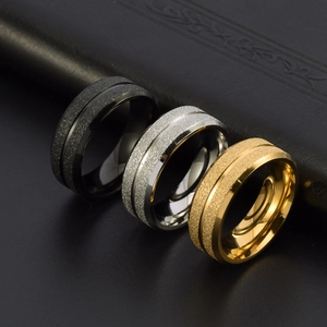 Mens matte black and silver stainless steel rings with center groove on leather background
