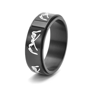 Minimalist black stainless steel spinner ring featuring white artistic script engraving