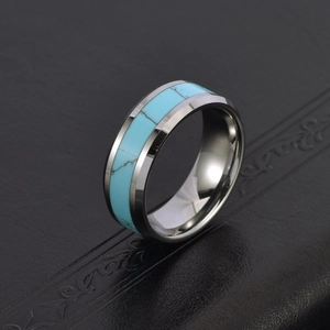 Polished tungsten ring with turquoise inlay and bevelled edges on black leather