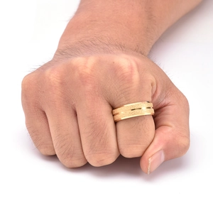 Detail of gold matte finish men's stainless steel ring with polished edges on model's hand