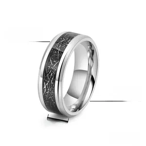 Macro detail of 8mm titanium steel ring with black carbon fiber inlay and polished finish