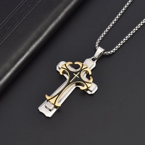 Detail of three-layer cross pendant with gold filigree and black enamel on box chain