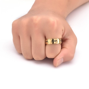 Detail of gold rotating ring featuring continuous pinky promise gesture engravings