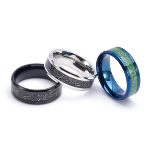 Detailed view of 8mm stainless steel rings with meteorite texture in black, silver, and blue