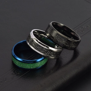 Three pieces of 8mm men's titanium steel rings with carbon fiber inlay on leather background
