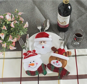 Christmas cutlery holders set with Santa, snowman and reindeer on a festive table