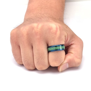 Detail of 8mm men's titanium ring featuring blue edges and green textured inlay