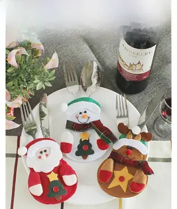 Detailed view of festive Santa and Snowman felt cutlery holders for Christmas table decor