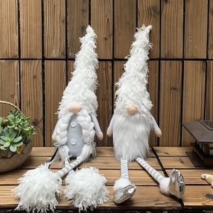 Detail of grey and white plush Christmas gnomes with long legs and striped knit design
