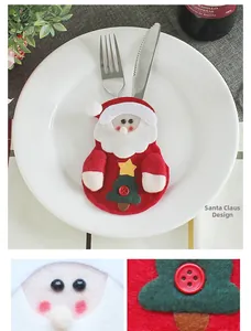 Detail of Santa Claus felt cutlery holder with small green tree and button decoration