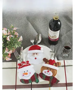 Close-up of Santa Claus, Snowman and Reindeer felt cutlery holders on a dining table