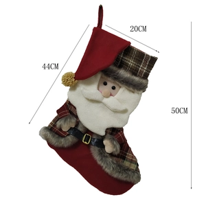 Large red knitted Christmas stocking with plaid detail and Santa Claus 3D figure