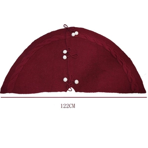 Deep red knitted Christmas tree skirt with cable knit pattern and white pom poms 122cm