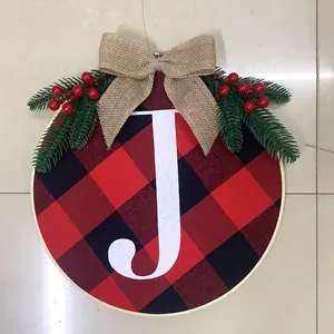 Detail of Christmas JOY door hanging featuring red black buffalo plaid and jute bow decoration