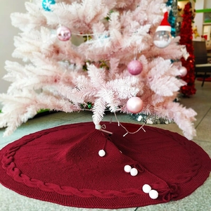 Knitted wine red Christmas tree skirt with cable knit pattern and white pom poms