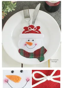 Detailed view of snowman cutlery holder with festive red hat and plaid scarf details