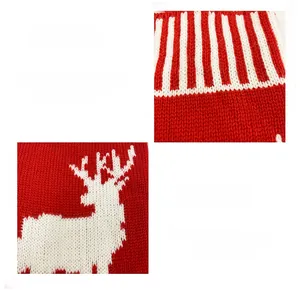 Close-up of knitted Christmas stocking with white reindeer motif and stripe patterns