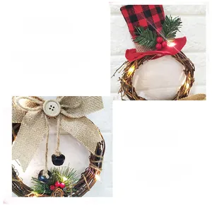Close-up of LED Christmas wreath with snowman hat, pine cones, and burlap bow details