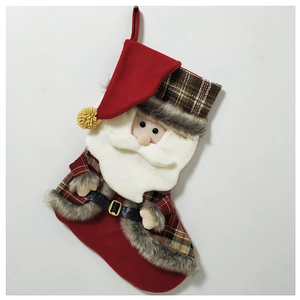 Close-up of a large Christmas stocking with 3D Santa Claus and classic plaid fabric patterns