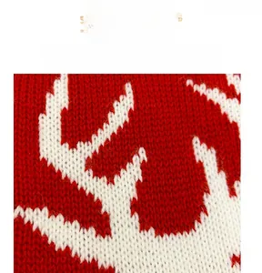 Close-up of red and white knitted Christmas stocking featuring a reindeer pattern weave