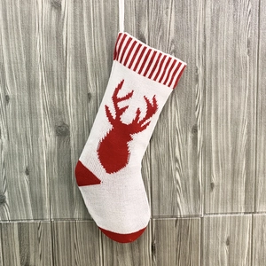 Knitted Christmas stockings with red reindeer patterns and hanging loops for holiday decor