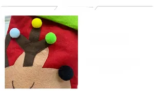 Detail of red Christmas stocking featuring brown reindeer antlers and colorful pom-poms