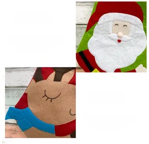 Detail of Christmas felt stockings featuring Santa and reindeer with neat patchwork stitching