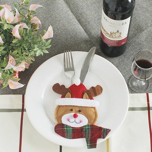 Christmas reindeer cutlery holder on a white plate for festive dining table decoration