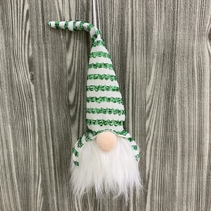 Detail of a green and white striped sequin gnome Christmas tree hanging ornament