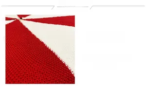 Detail of red and white knitted Christmas tree skirt with premium fringe and textures