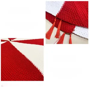Detail of red and white chunky knit Christmas tree skirt with decorative soft fringe