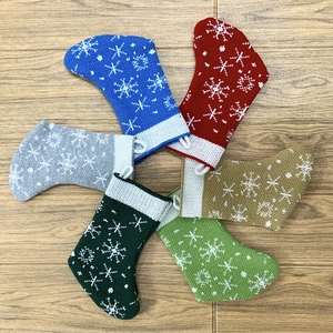 Set of six colorful knitted Christmas stockings with snowflake patterns and hanging loops
