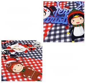 Detail of Christmas fabric bags featuring snowman and Santa Claus with plaid patterns
