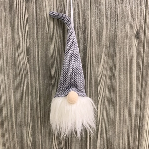 Detail of Nordic gnome ornament with grey knitted hat and soft white plush beard decoration