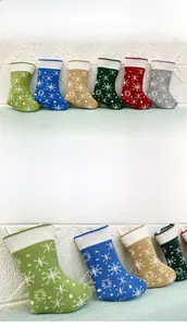 Detail view of knitted Christmas stocking set with woven snowflake patterns in six colors