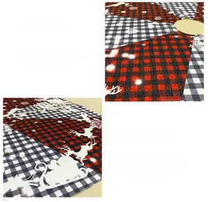 Detail of buffalo plaid Christmas tree skirt with reindeer, sleigh and snowflake prints