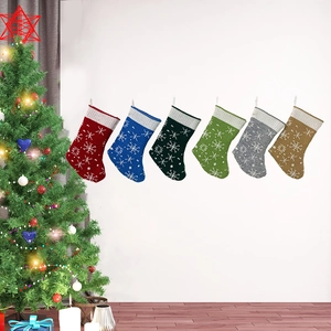 Detailed view of six colorful knitted Christmas stockings with white snowflake patterns