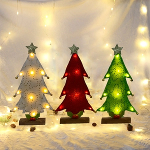 Three felt Christmas trees with LED lights, sequins, and wooden bases in red, white and green