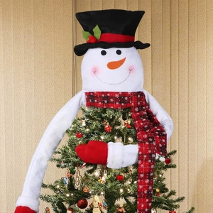 Detailed plush snowman Christmas tree topper with red scarf and mittens on decorated tree