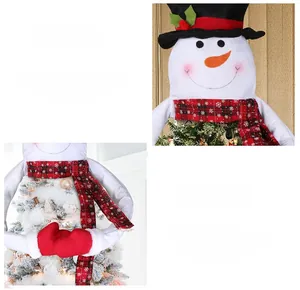 Detail view of a snowman Christmas tree topper with red scarf and black top hat