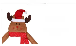 Detail of plush reindeer Christmas chair cover with red hat and snowflake scarf
