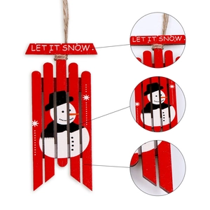Detail view of red wooden Christmas sledge ornament with Let It Snow text and snowman